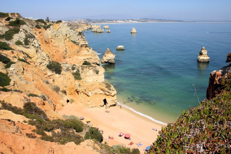 The creamy cliffs and yellow sand of Praia do camilo in Lagos