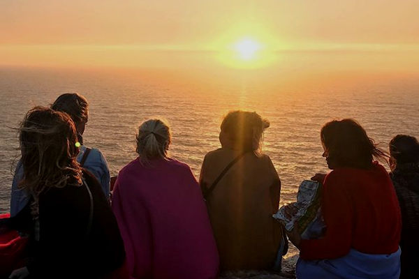 alt="group of friends at sunset"