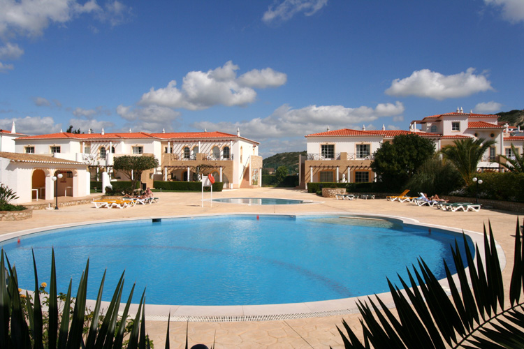 The bright blue swimming pool is the fabulous centrepiece of the Luz Bay Hotel