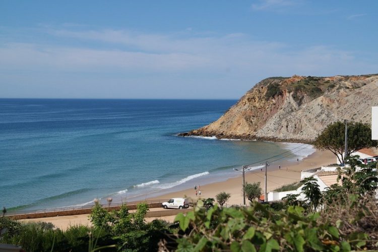 The fishing village of Burgau is also a surf town with constant waves against the horseshoe bay beach