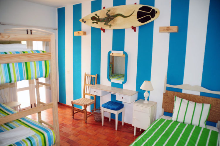 j'hola surf camp The striped blue and white dormitory room at the j'hola surf camp offers a positive vibe