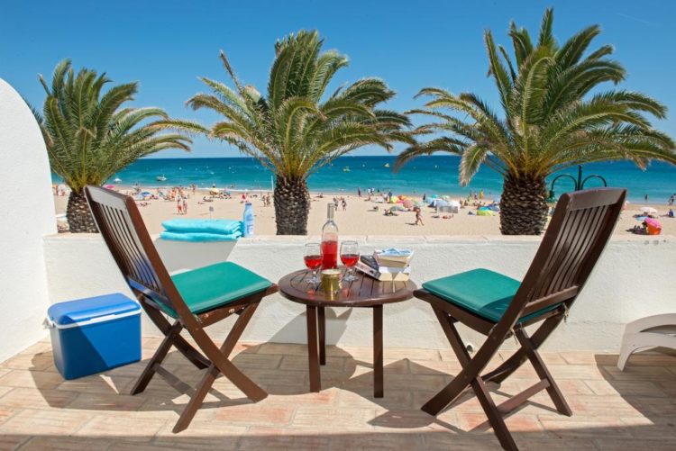 luz beach apts The view from the balcony of Luz Beach Apartments faces the main beach and ocean at Praia da Luz. It features two chairs and a small table