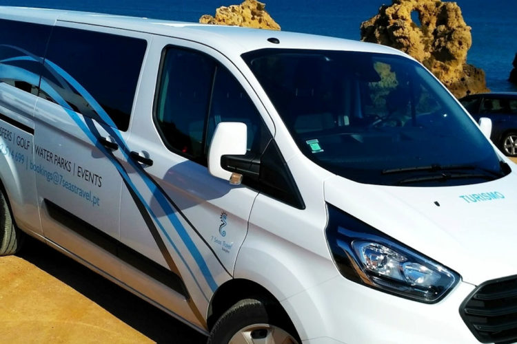 A large white minibus perfect for families against the backdrop of the sea