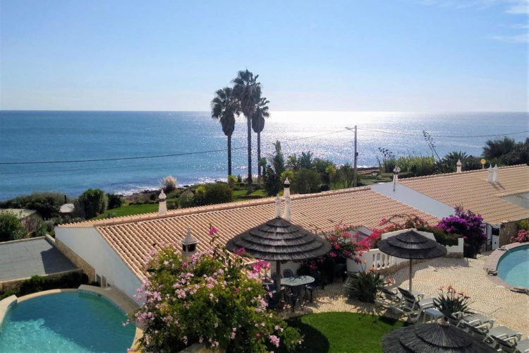 The view from the one bedroom apartment offers blue sea, blue skies and a blue swimming pool
