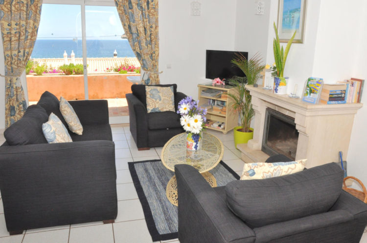 The lounge offers three chairs, a fireplace, a television and views from the terrace