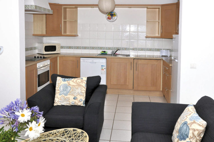 The lounge and kitchen is open planned with an oven, fridge, dishwasher and full kitchen